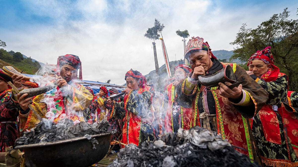 Red Dao ritual specialists blowing horns during a Lễ Cấp Sắc ceremony in northern Vietnam