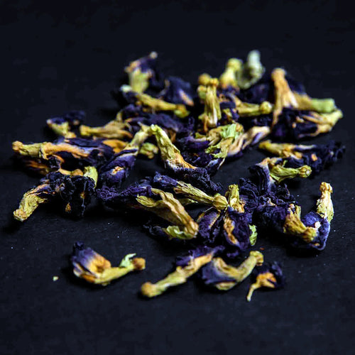 Clitoria ternatea butterfly pea flower tea whole dried blue flowers on a black background