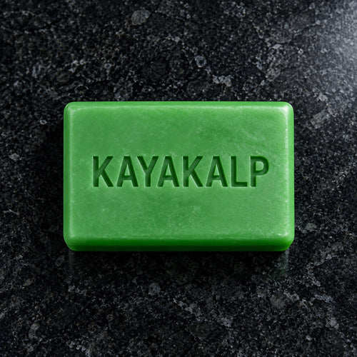 Sacred Plants Australia Kayakalp Ayurvedic bath soap, green bar with recessed KAYAKALP lettering photographed directly from above on dark polished stone