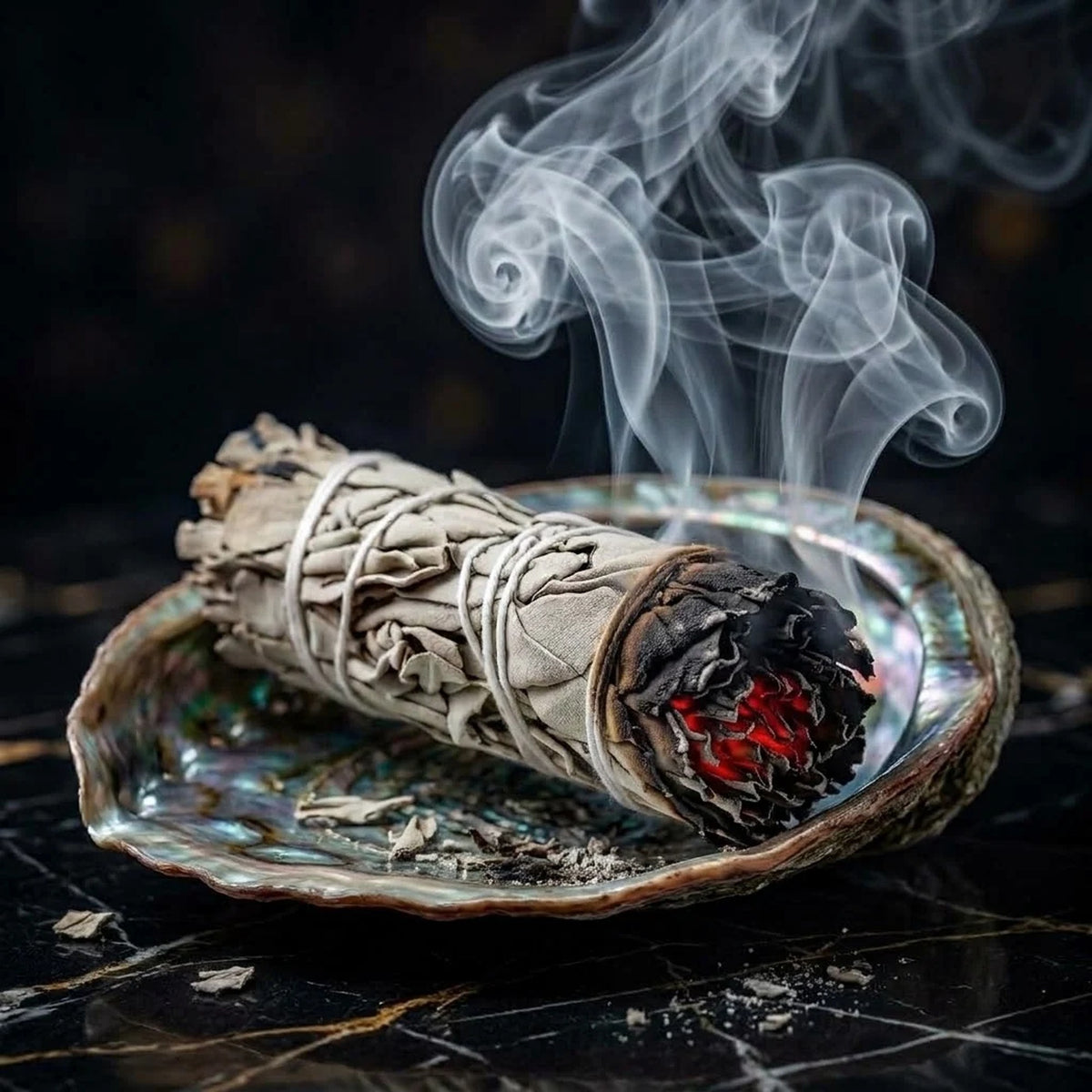 Mexican White Sage smudge stick smouldering on an abalone shell