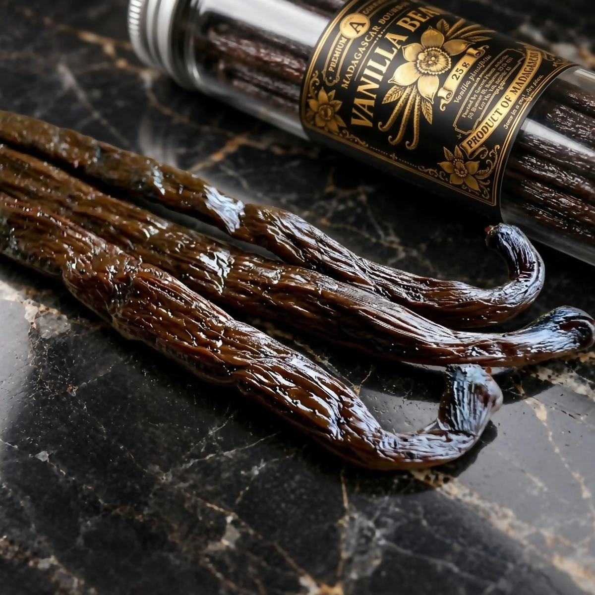 Sacred Plants Australia Madagascar Bourbon Vanilla Beans (Vanilla planifolia), glossy whole cured vanilla beans beside the black and gold labelled protective vial on dark marble