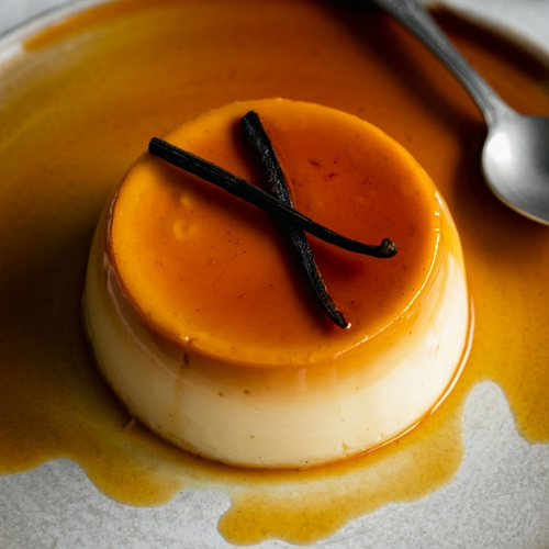 Madagascar Bourbon Vanilla Extract culinary inspiration, vanilla panna cotta with caramel sauce and vanilla pods on a ceramic plate