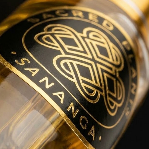 Extreme diagonal macro of SANANGA Sacred Plants Australia black-and-gold bottle label