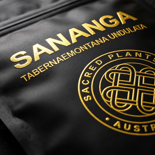 Extreme close-up of gold-foil SANANGA and Tabernaemontana undulata lettering and Sacred Plants Australia emblem on a black Mylar pouch.