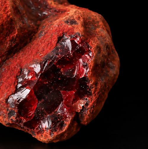 Extreme macro of a red Socotran Dragon's Blood resin specimen showing a glossy dark crimson interior