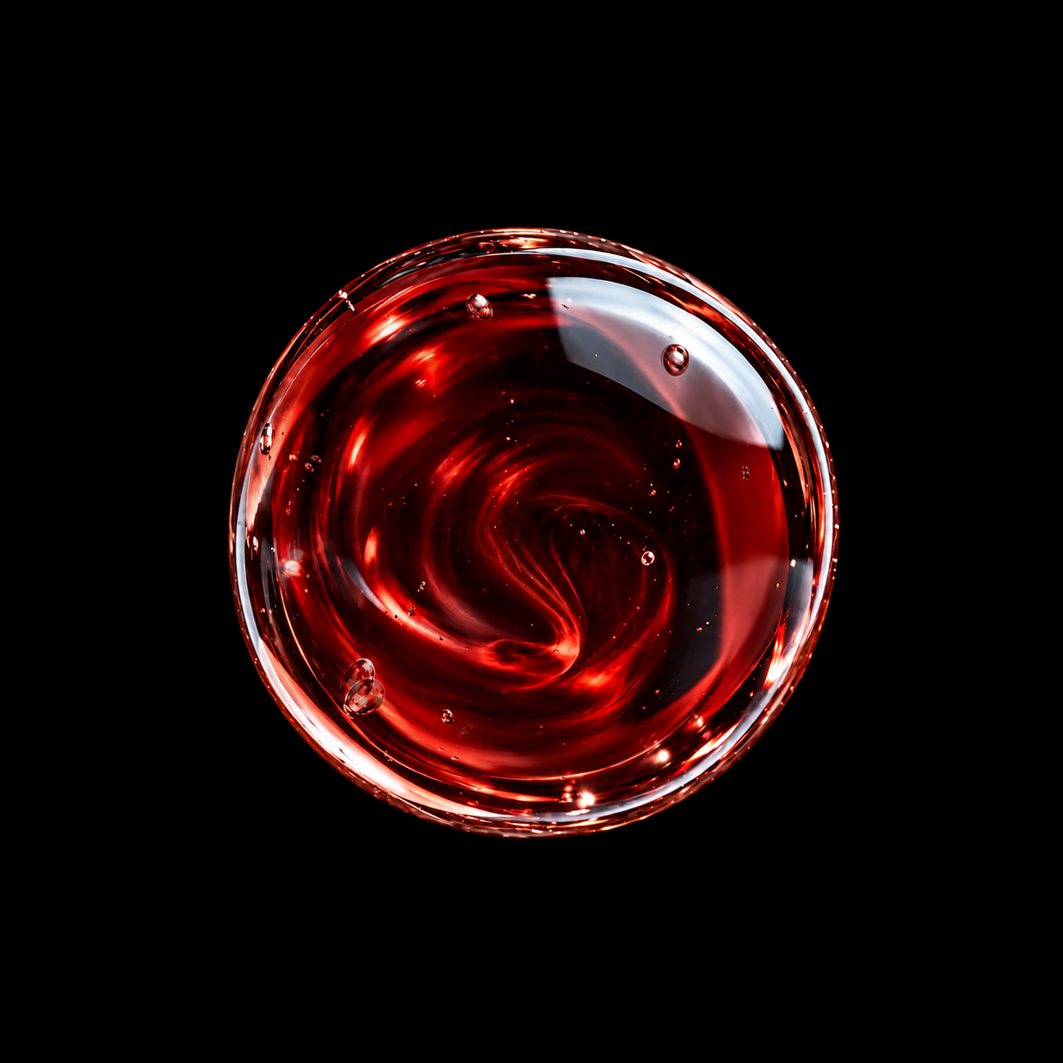 Socotra Dragon's Blood Resin Infused Oil — deep crimson vortex macro on black background