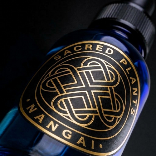 Ultra-close-up of the circular gold Sacred Plants Australia Nangai label on a cobalt-blue glass dropper bottle.